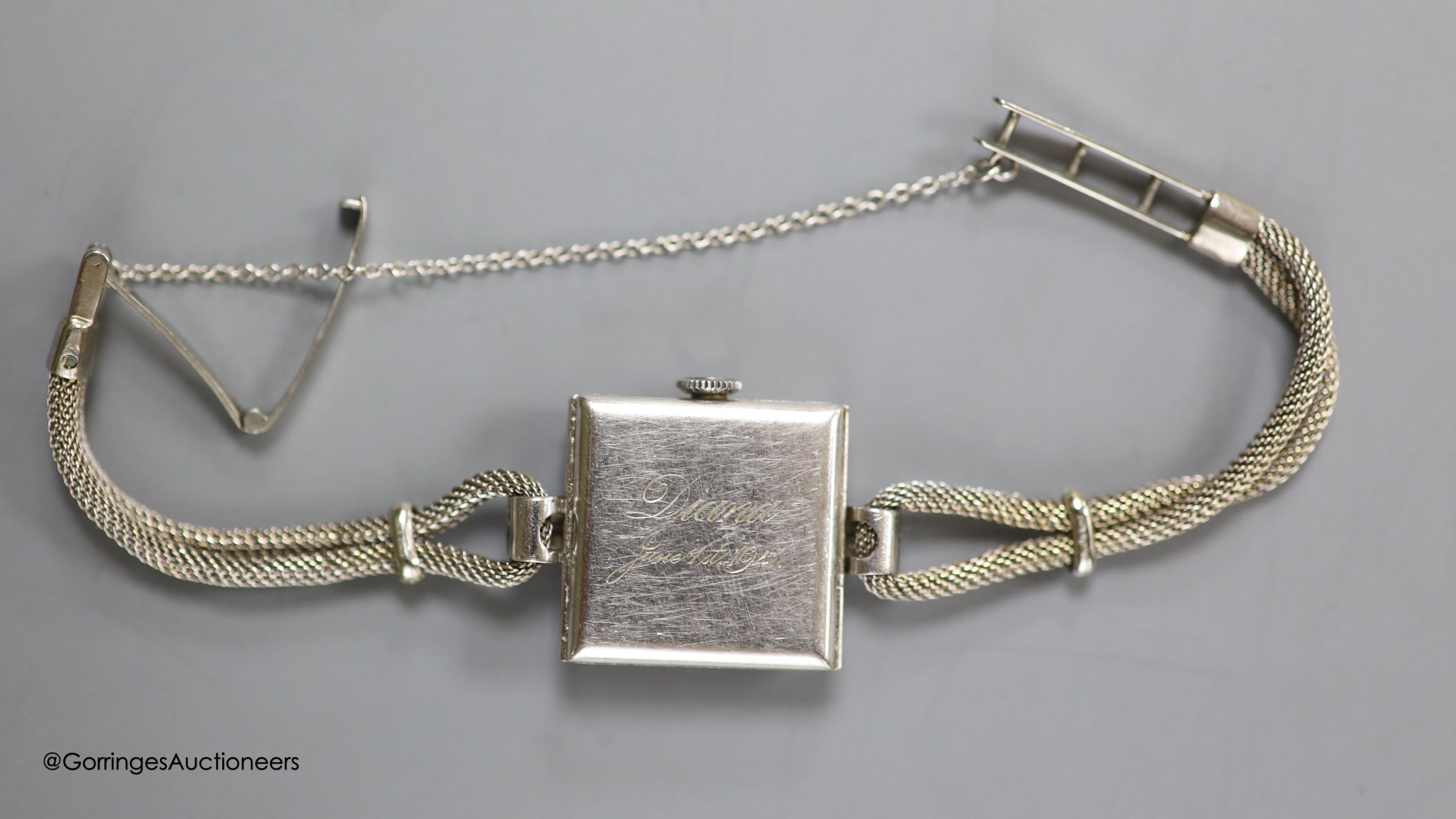 A lady's 1940's white metal (stamped platinum) and diamond set Vertex manual wind square dial cocktail watch, on a 9ct twin strand bracelet